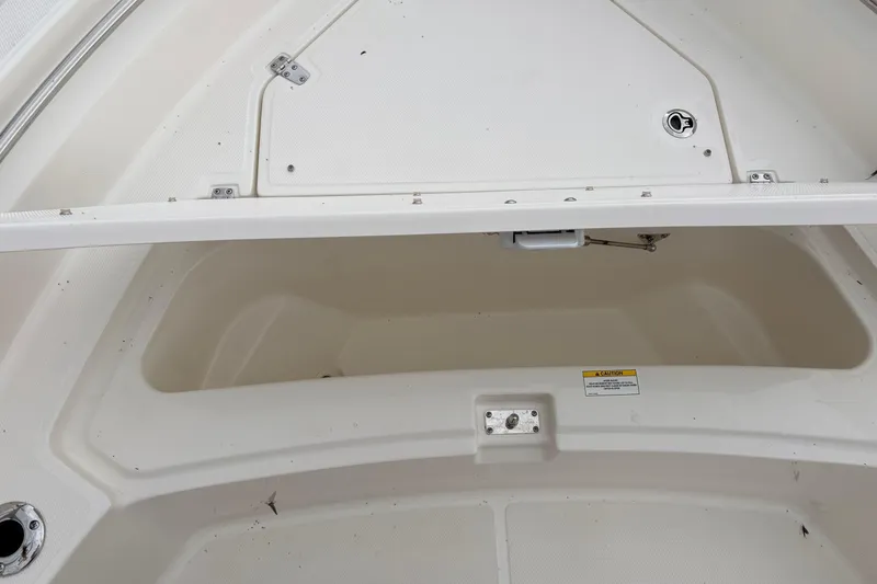 Slide: The Image of Open storage compartment on a 2026 Boston Whaler 22 Dauntless boat. - 16