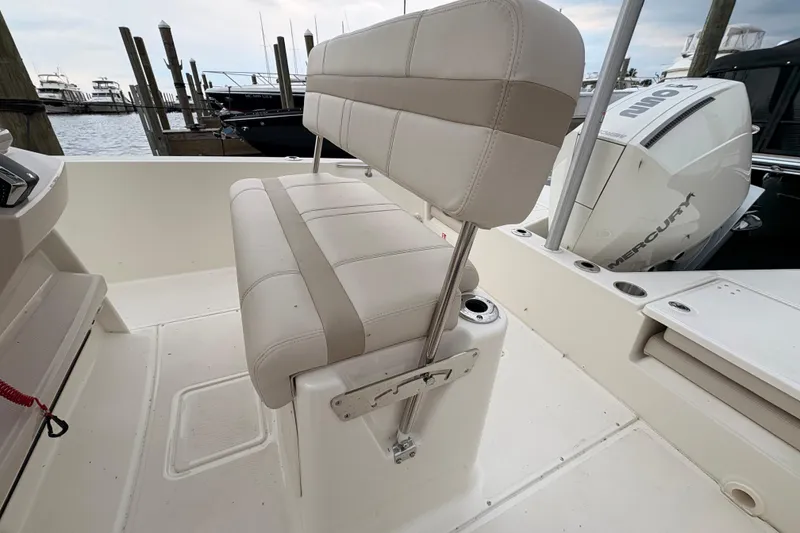 Slide: The Image of 2026 Boston Whaler 22 Dauntless boat interior with seating and Mercury engine. - 6