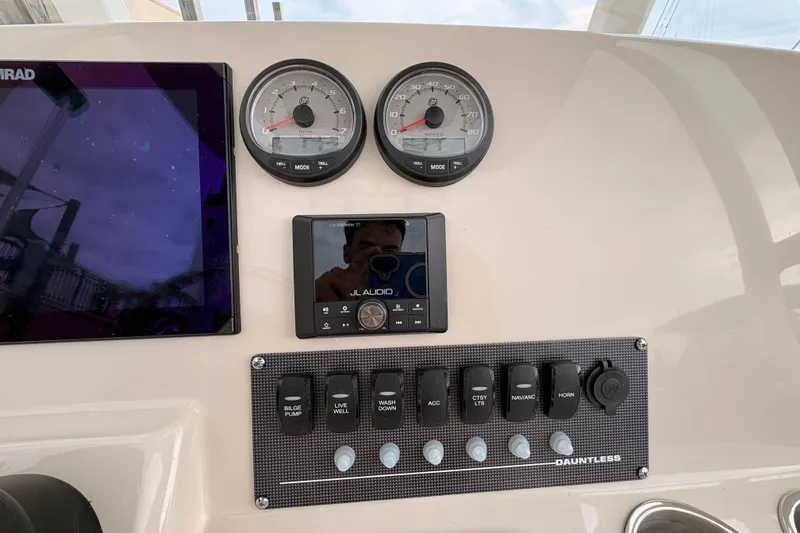 Slide: The Image of Dashboard of 2026 Boston Whaler 22 Dauntless with gauges and control panel. - 8