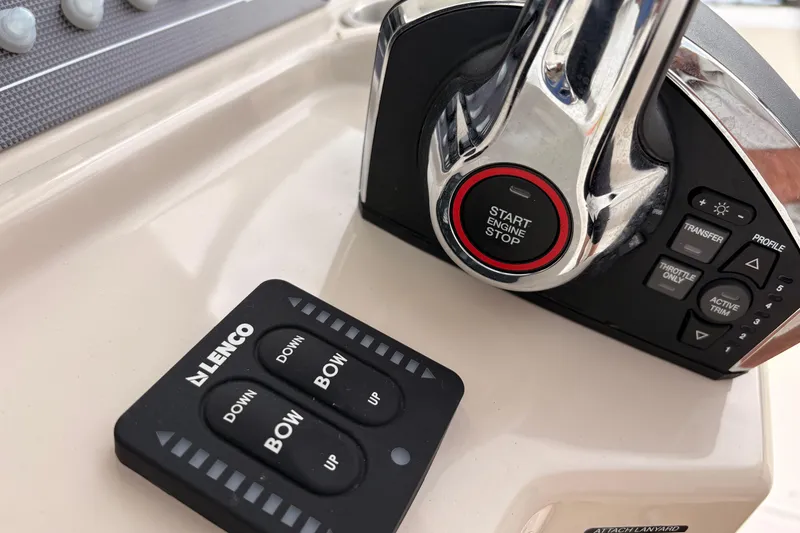 Slide: The Image of Control panel of 2026 Boston Whaler 22 Dauntless boat with start button and trim controls. - 9