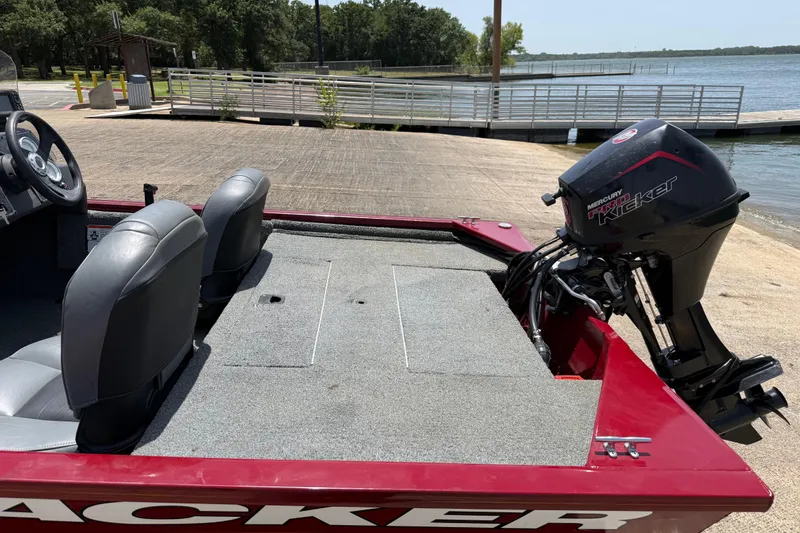 Slide: The Image of 2019 Tracker Pro 160 boat with Mercury Pro Kicker motor at a lakeside dock. - 24