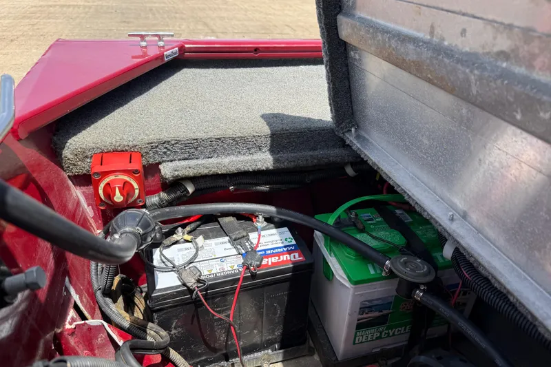 Slide: The Image of 2019 Tracker Pro 160 boat battery compartment with dual batteries and wiring. - 26