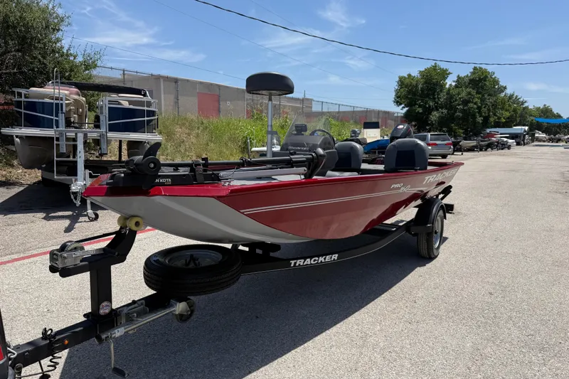 The Image of 2019 Tracker Pro 160 boat on trailer, parked outdoors under clear sky. - 2