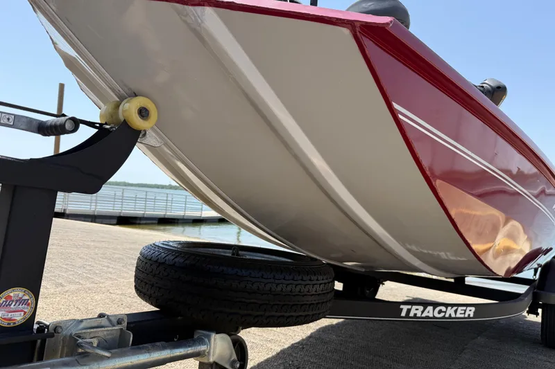 Slide: The Image of 2019 Tracker Pro 160 boat on trailer, close-up view of hull and wheel. - 18
