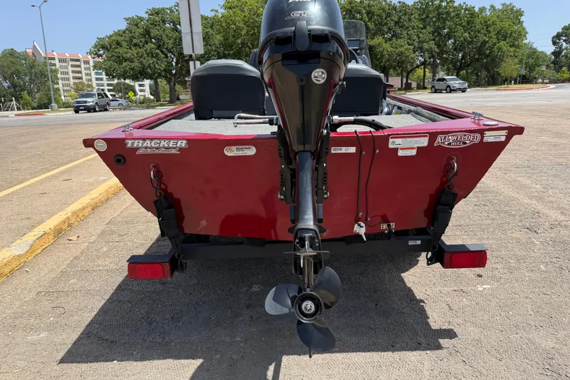Slide: The Image of 2019 Tracker Pro 160 boat with outboard motor, parked on a sunny day. - 9