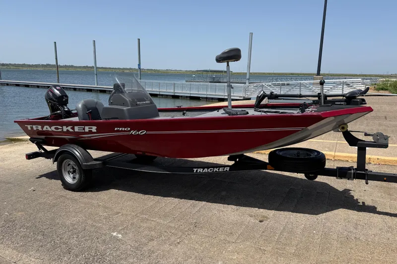 Slide: The Image of 2019 Tracker Pro 160 boat on trailer by a lakeside dock. - 15