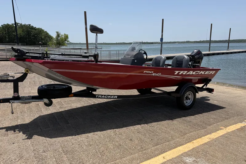 Slide: The Image of 2019 Tracker Pro 160 boat on trailer by a lake, ready for fishing. - 2