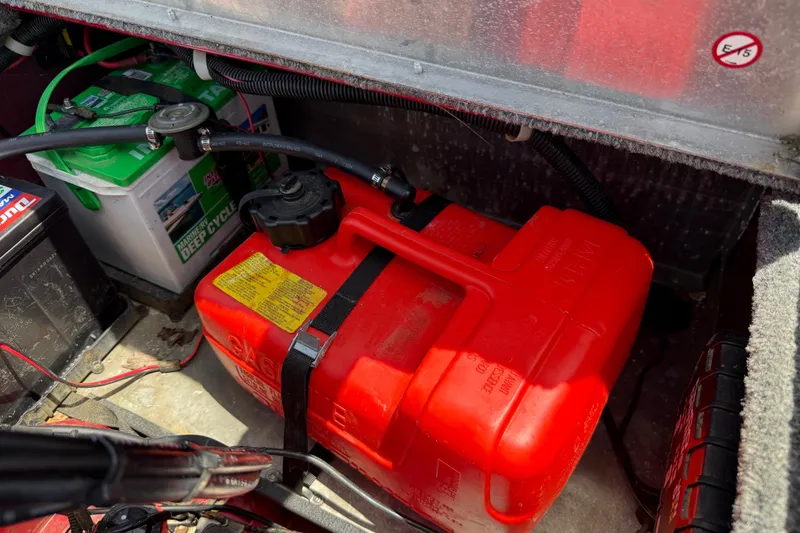 Slide: The Image of 2019 Tracker Pro 160 boat battery and fuel tank compartment with red gas can. - 25