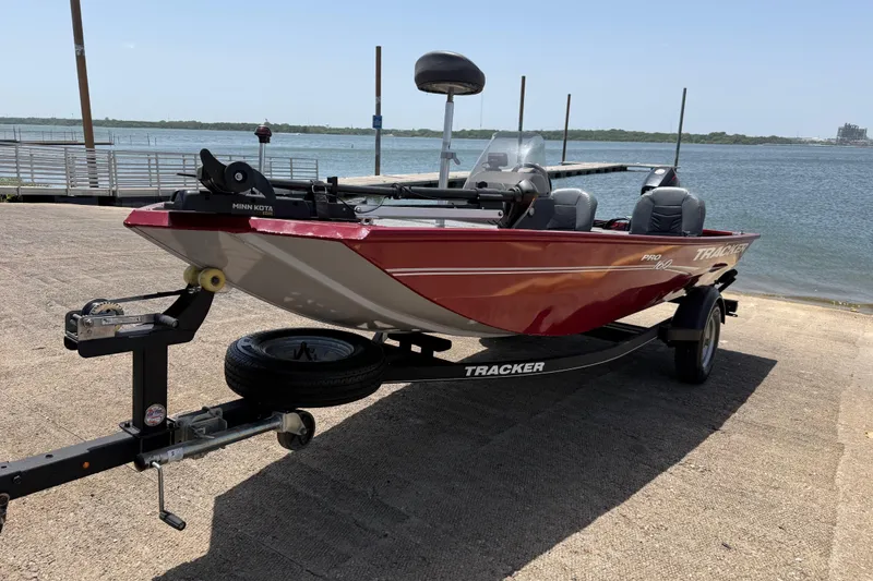 The Image of 2019 Tracker Pro 160 boat on trailer by waterfront, ready for launch. - 0