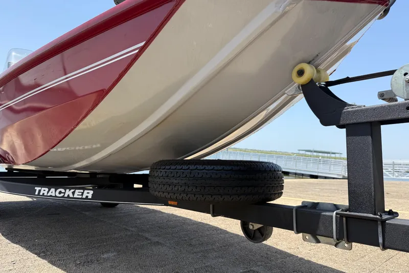 Slide: The Image of 2019 Tracker Pro 160 boat on trailer, close-up view of hull and wheel. - 17