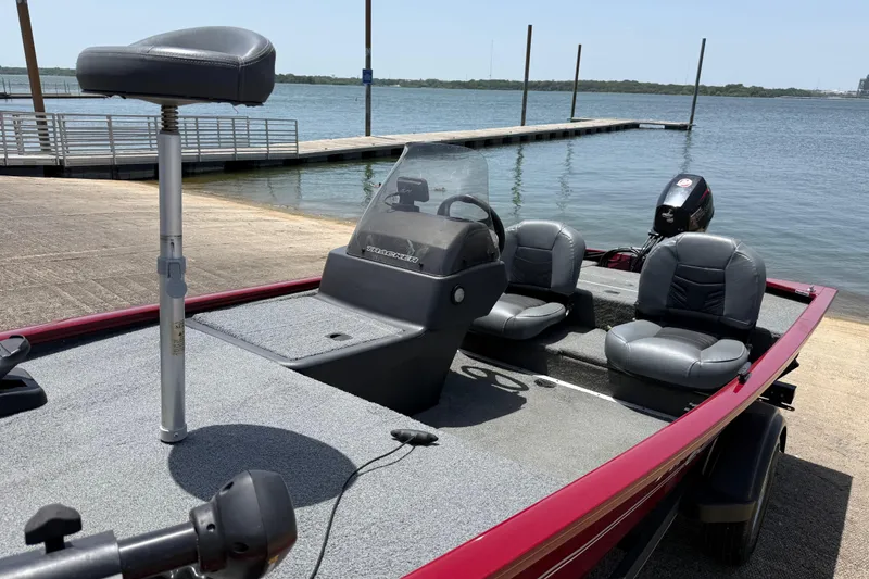 Slide: The Image of 2019 Tracker Pro 160 boat docked by a serene lake. - 21