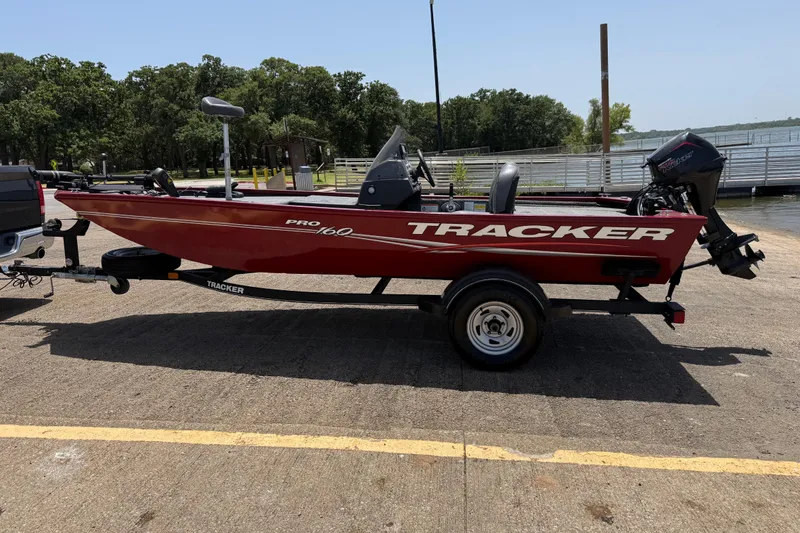 Slide: The Image of 2019 Tracker Pro 160 boat on trailer near a lakeside dock. - 5