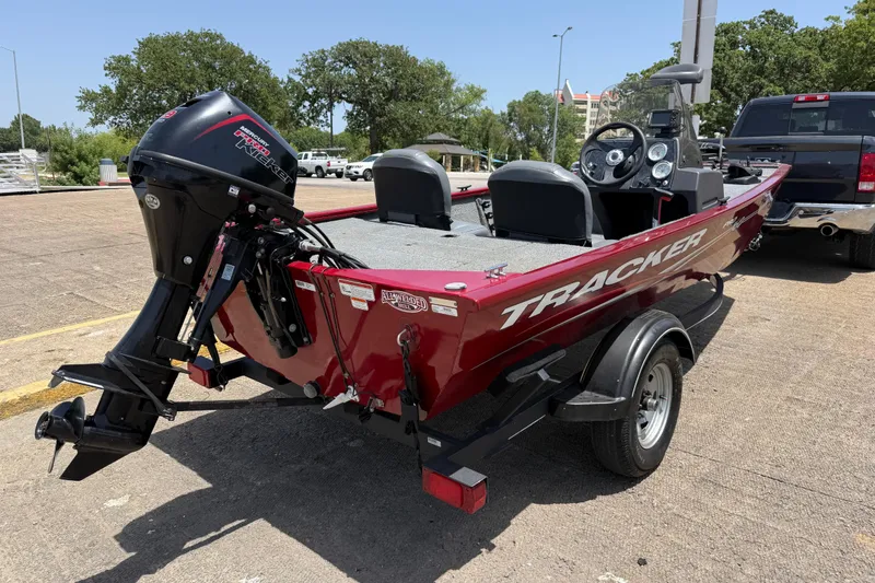 Slide: The Image of 2019 Tracker Pro 160 boat on trailer, featuring a sleek red design and powerful outboard motor. - 11