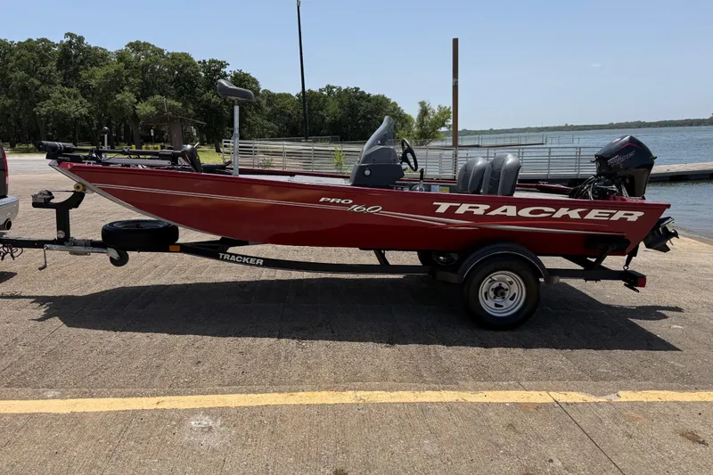 Slide: The Image of 2019 Tracker Pro 160 boat on trailer by a lakeside dock. - 4