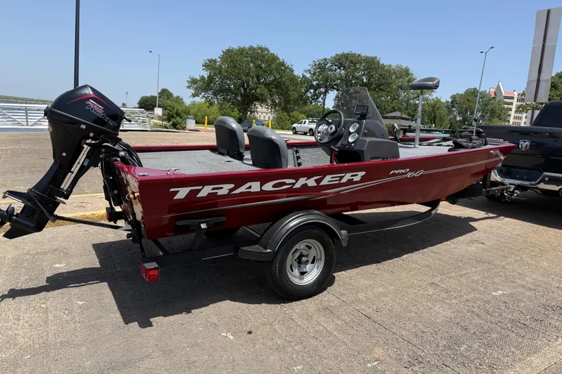 Slide: The Image of 2019 Tracker Pro 160 boat on trailer, parked outdoors on a sunny day. - 12