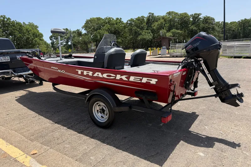 Slide: The Image of 2019 Tracker Pro 160 boat on trailer, parked outdoors, ready for transport. - 7