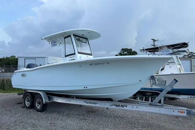 The Image of 2018 Sea Hunt Ultra 255 SE boat on trailer, parked outdoors. - 0