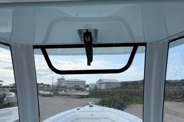 Slide: The Image of 2018 Sea Hunt Ultra 255 SE boat windshield view with marina background. - 10