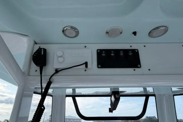 Slide: The Image of 2018 Sea Hunt Ultra 255 SE boat dashboard with controls and radio equipment. - 11