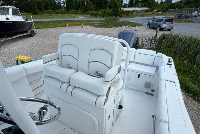 Slide: The Image of 2018 Sea Hunt Ultra 255 SE boat interior with white seating and steering wheel. - 17