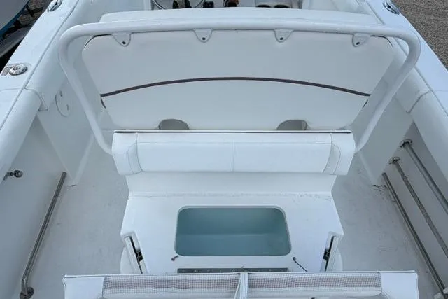 Slide: The Image of 2018 Sea Hunt Ultra 255 SE boat interior with seating and storage compartment. - 19
