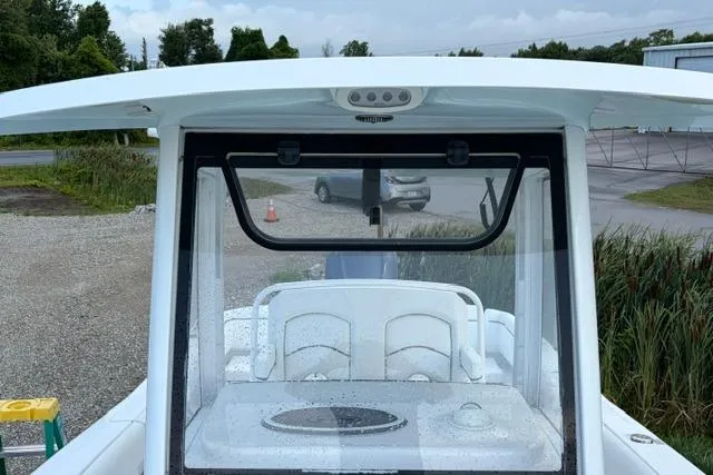Slide: The Image of 2018 Sea Hunt Ultra 255 SE boat with a sleek white design and spacious seating. - 9