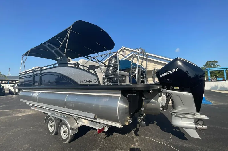Slide: The Image of 2025 Harris Solstice 250 SLEC pontoon boat with Mercury engine on trailer. - 10