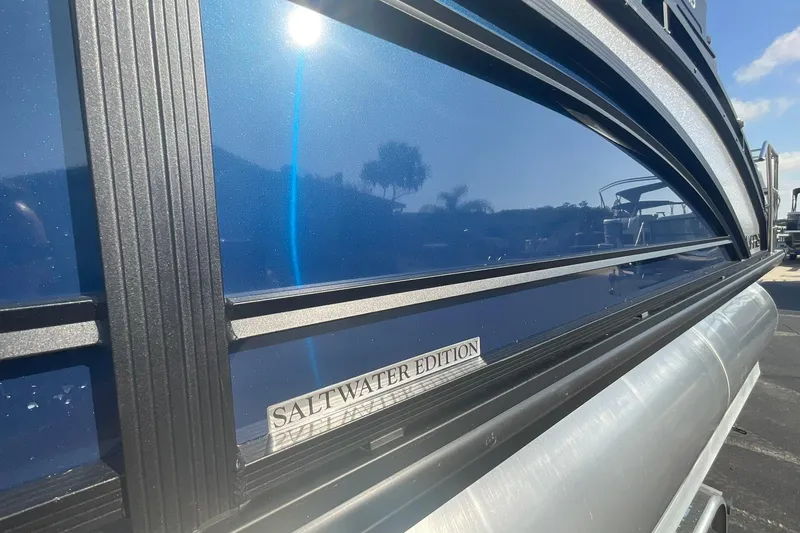 Slide: The Image of 2025 Harris Solstice 250 SLEC Saltwater Edition pontoon boat with sleek blue exterior. - 11