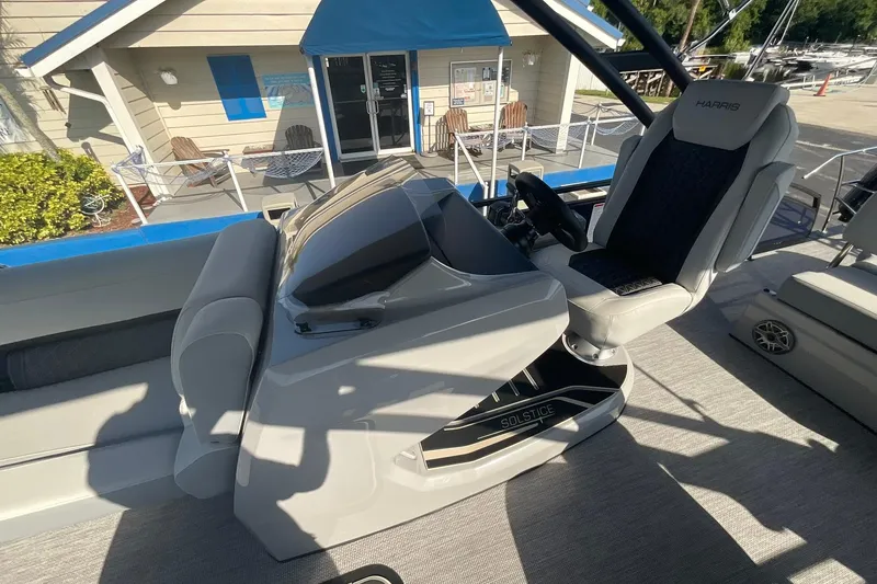 Slide: The Image of 2025 Harris Solstice 250 SLEC boat interior with helm and captain's chair. - 13