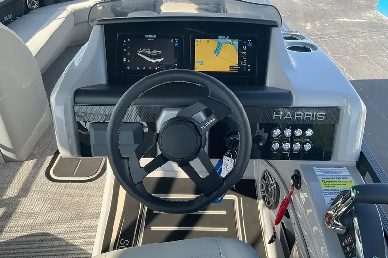 Slide: The Image of 2025 Harris Solstice 250 SLEC boat dashboard with steering wheel and digital displays. - 14