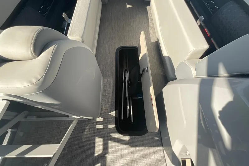 Slide: The Image of 2025 Harris Solstice 250 SLEC boat interior with open storage compartment. - 25