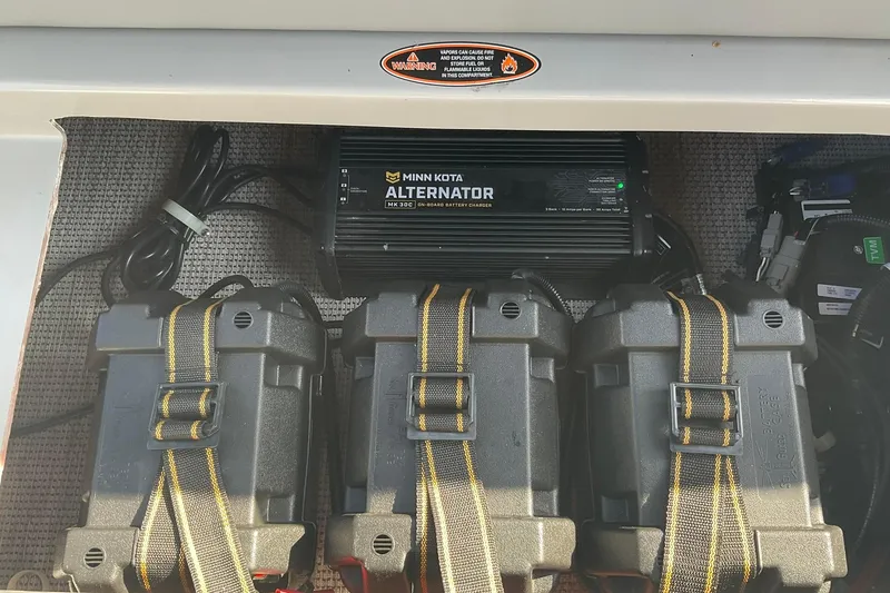Slide: The Image of Battery compartment of 2025 Harris Solstice 250 SLEC with Minn Kota alternator charger. - 29