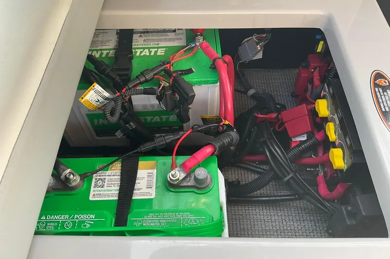 Slide: The Image of Battery compartment of 2025 Harris Solstice 250 SLEC with Interstate batteries and wiring. - 30