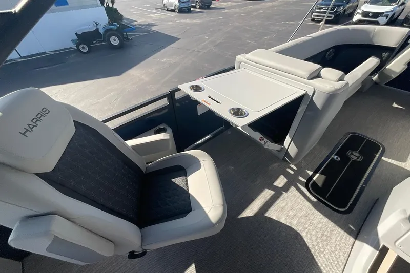 Slide: The Image of Interior of 2025 Harris Solstice 250 SLEC boat with seating and table setup. - 34
