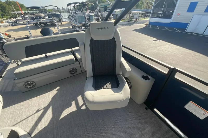 Slide: The Image of Luxurious seating on 2025 Harris Solstice 250 SLEC pontoon boat, docked at marina. - 39