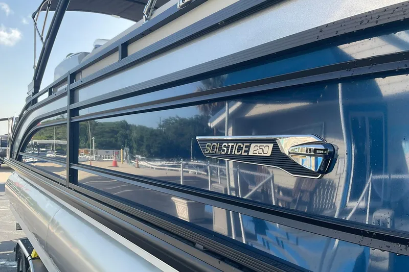 Slide: The Image of 2025 Harris Solstice 250 SLEC pontoon boat with sleek blue exterior detailing. - 6