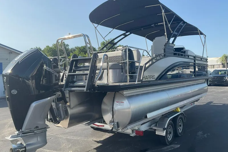 Slide: The Image of 2025 Harris Solstice 250 SLEC pontoon boat with Mercury engine on trailer. - 8