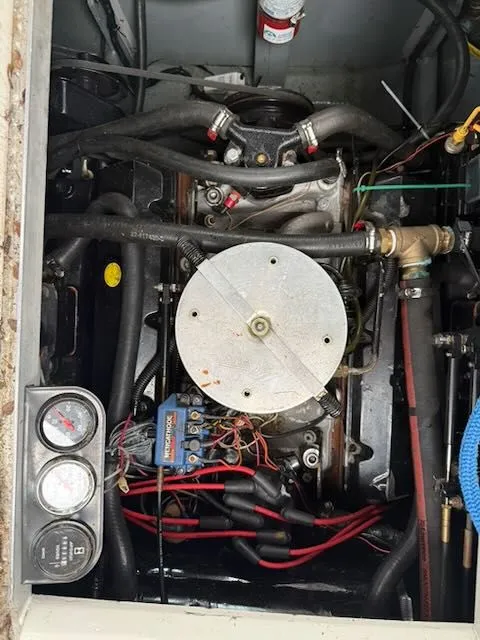 Slide: The Image of Engine compartment of a 1994 Sea Ray 270 with visible hoses, wires, and gauges. - 11