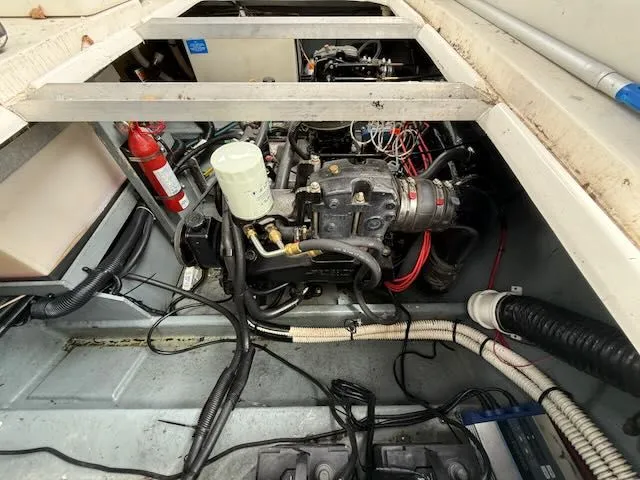 Slide: The Image of The engine compartment of a 1994 Sea Ray 270 boat shows the engine and wiring. - 12