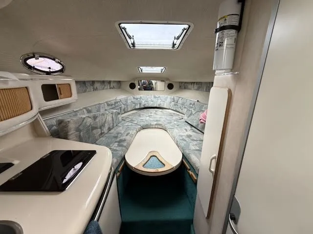Slide: The Image of Interior of a 1994 Sea Ray 270 with cozy seating area and skylight. - 13