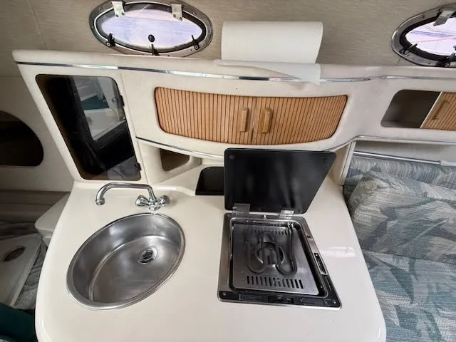 Slide: The Image of Interior view of a 1994 Sea Ray 270 with a sink and stove. - 18
