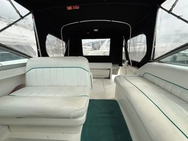 Slide: The Image of Interior of a 1994 Sea Ray 270 with white seating and green carpet. - 3