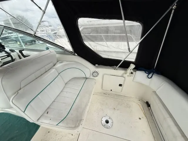 Slide: The Image of Interior of a 1994 Sea Ray 270 with white seating and black trim. - 4