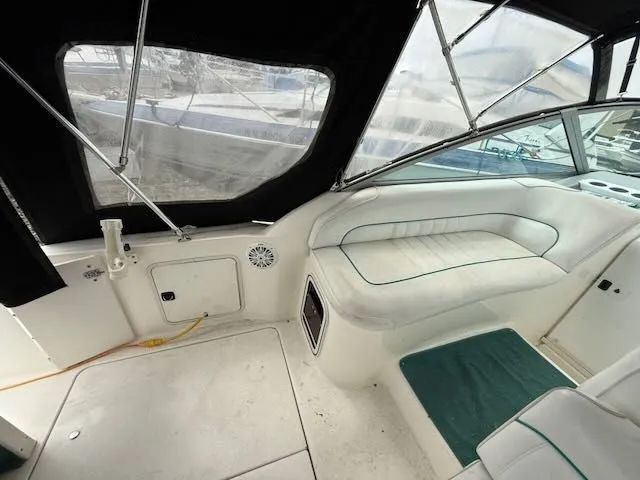Slide: The Image of Interior of a 1994 Sea Ray 270 with white seating and windows. - 5