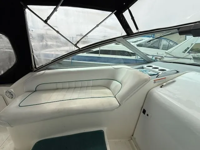Slide: The Image of Interior of a 1994 Sea Ray 270 with white upholstery and windows. - 6