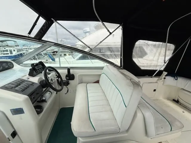 Slide: The Image of The image shows the cockpit of a 1994 Sea Ray 270 boat with white seating. - 7