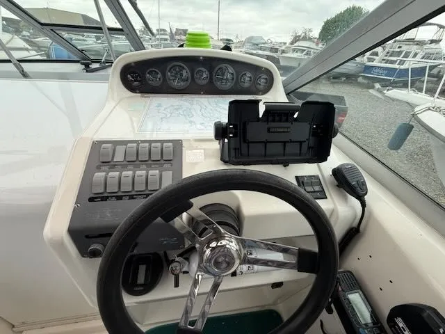Slide: The Image of The image shows the helm of a 1994 Sea Ray 270 boat with instruments and a chart holder. - 8
