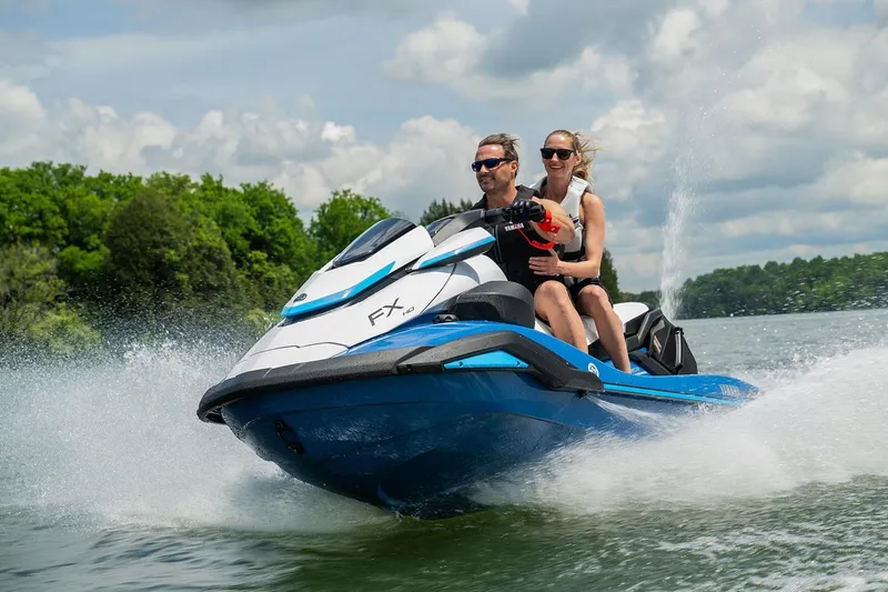 Slide: The Image of Manufacturer Provided Image: 2026 Yamaha WaveRunner FX HO jet ski on a lake with two riders enjoying the ride. - 2