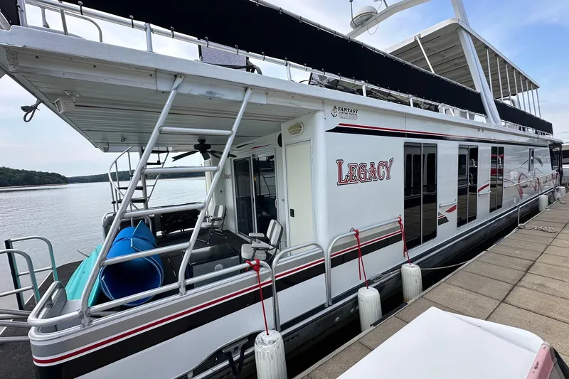 Slide: The Image of Houseboat "Legacy" docked, Fantasy 18x82 model, 2001, with upper deck and water slide. - 1