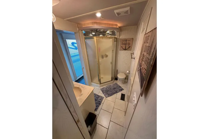 Slide: The Image of Compact bathroom with shower, toilet, and nautical decor in a 2001 Fantasy 18x82 model. - 12